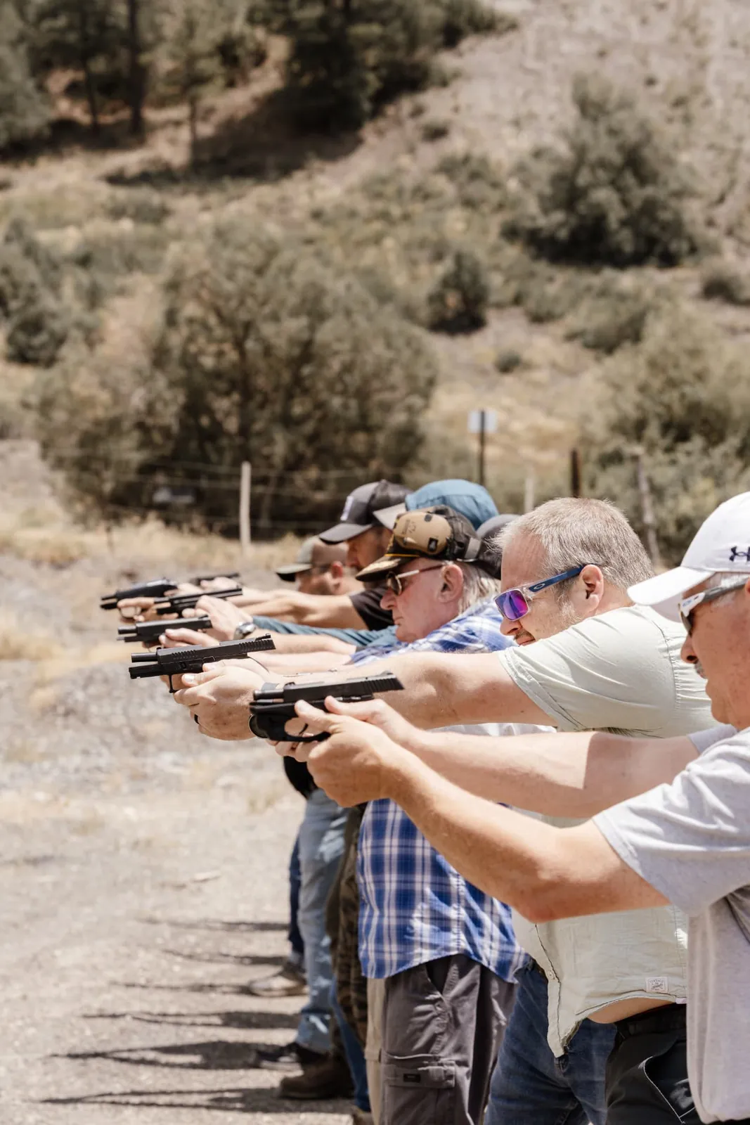A full firing line of students shooting together on a Colorado range